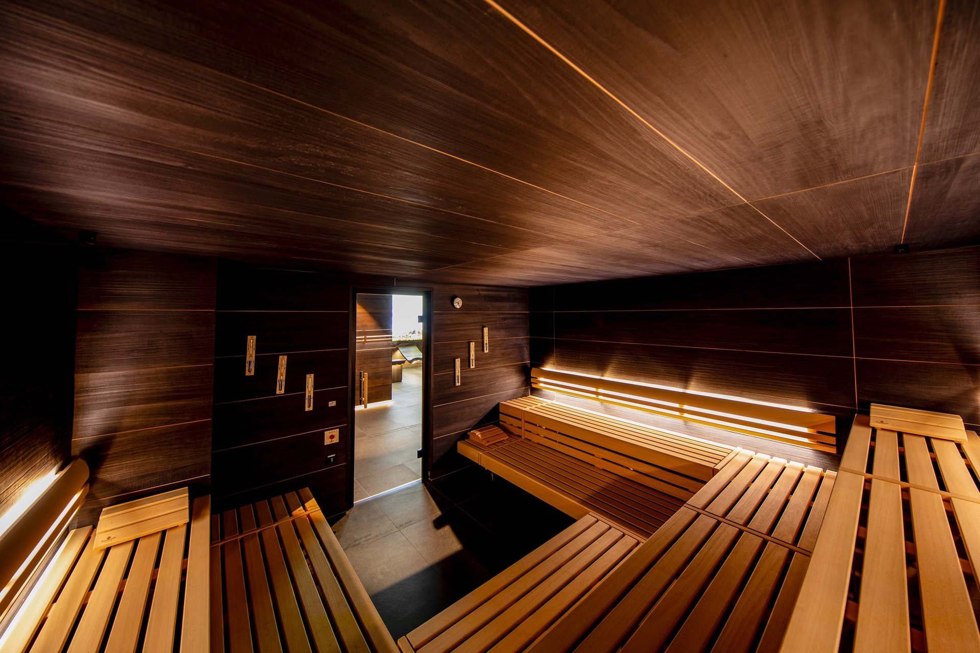 Das Sporthotel in Jena Innenansicht einer modernen Holzsauna mit Sitzbänken und indirekter Beleuchtung